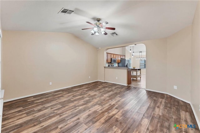 unfurnished living room featuring lofted ceiling, ceiling fan, visible vents, and dark wood-style flooring