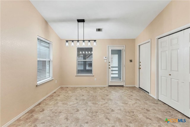 unfurnished dining area with baseboards and visible vents