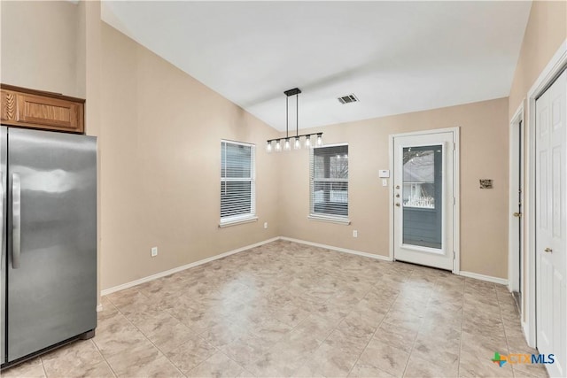 unfurnished dining area with vaulted ceiling, visible vents, and baseboards