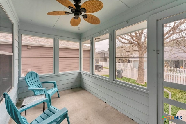 sunroom featuring ceiling fan