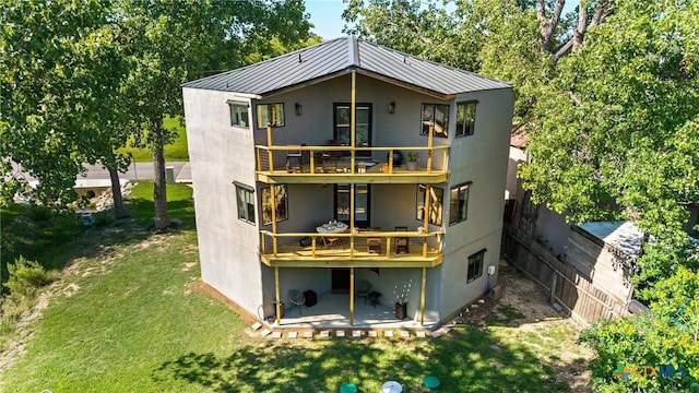 2201 Fuller Ln, Harker Heights, TX 76548 - back of house featuring a balcony, stucco siding, a yard, and a metal roof