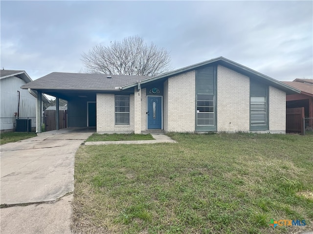 ranch-style house with central air condition unit, a front lawn, and a carport