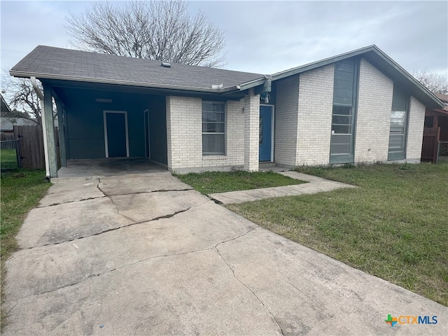 ranch-style house with a carport and a front yard