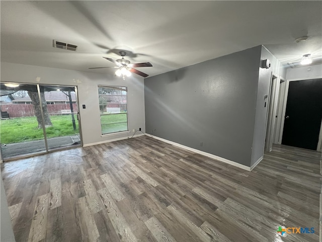 spare room with ceiling fan and dark wood-type flooring