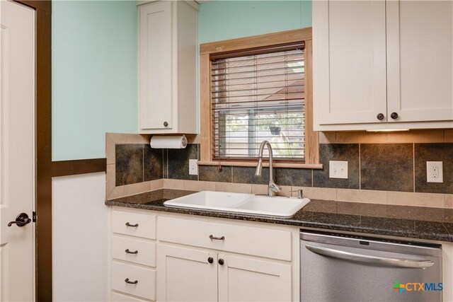 kitchen with tasteful backsplash, dark stone counters, sink, dishwasher, and white cabinetry