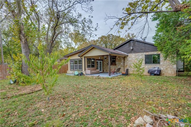 back of house with a lawn, ceiling fan, and a patio