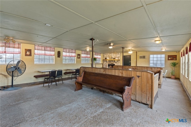 recreation room with ceiling fan, light colored carpet, and a fireplace