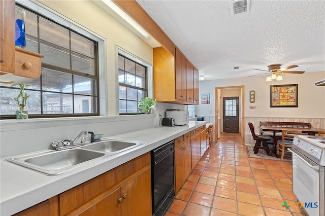 kitchen featuring dishwasher, sink, ceiling fan, a textured ceiling, and electric stove