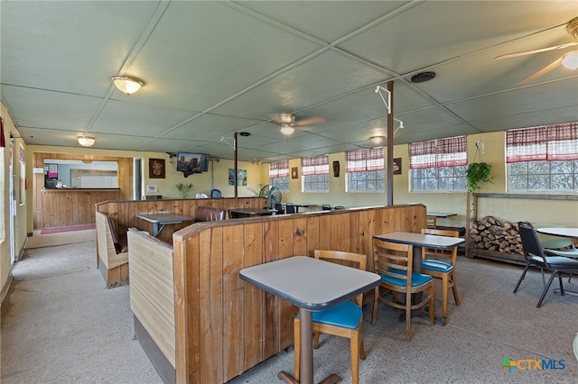 kitchen with a paneled ceiling, kitchen peninsula, and ceiling fan