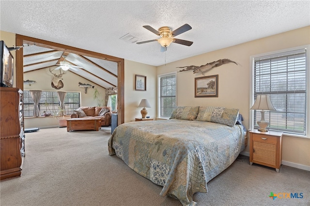 carpeted bedroom featuring ceiling fan, lofted ceiling, and a textured ceiling