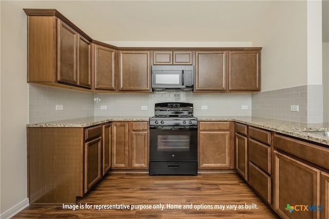 kitchen with black appliances, dark wood-type flooring, and tasteful backsplash