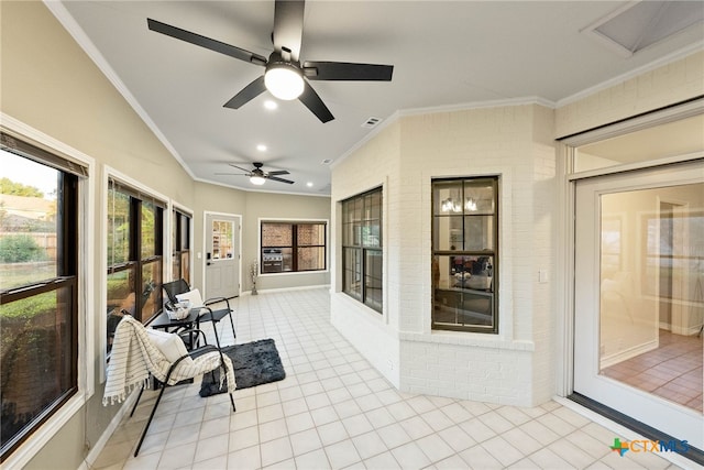 sunroom / solarium featuring ceiling fan