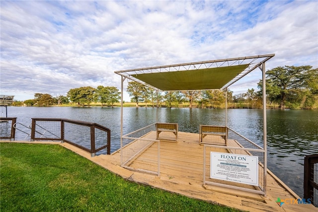 view of dock featuring a water view and a yard