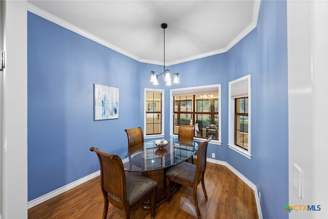 dining room with an inviting chandelier, wood-type flooring, and ornamental molding