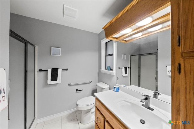 bathroom with vanity, a shower with shower door, tile patterned flooring, and toilet