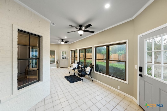 sunroom featuring lofted ceiling and ceiling fan