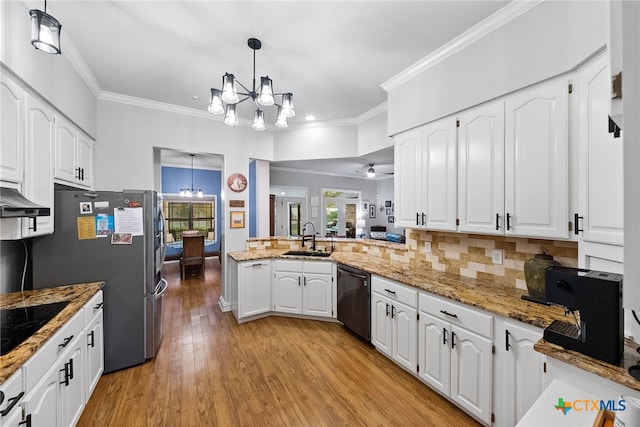 kitchen with light hardwood / wood-style floors, white cabinets, black appliances, sink, and hanging light fixtures