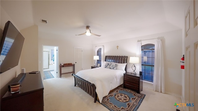 carpeted bedroom with ceiling fan and connected bathroom