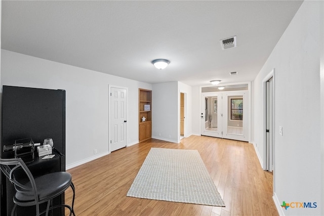 foyer featuring french doors and light wood-type flooring