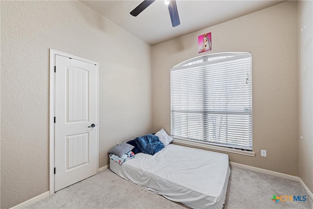 carpeted bedroom featuring ceiling fan and vaulted ceiling