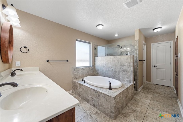 2515 Alpine Fir Dr, Harker Heights, TX 76548 - bathroom with a stall shower, a garden tub, double vanity, a textured ceiling, and tile patterned floors