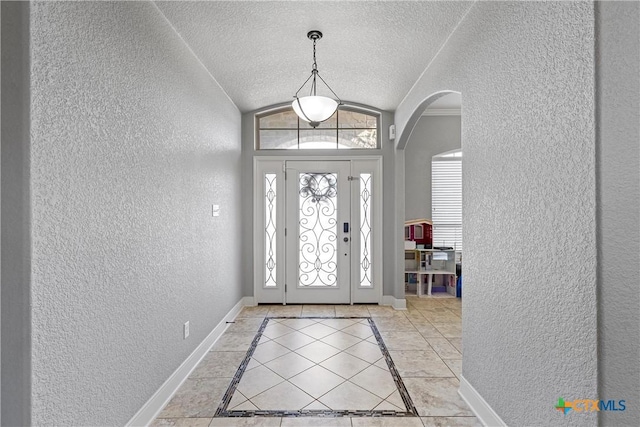 tiled entryway featuring vaulted ceiling