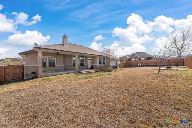 back of property with a patio area and a lawn