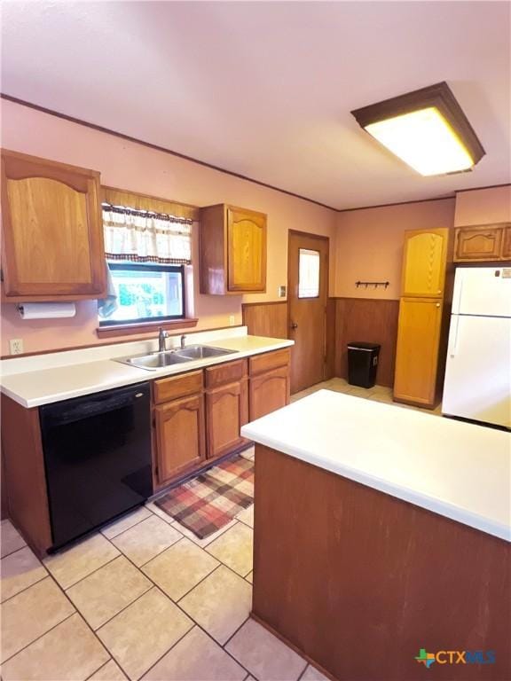 6769 Cedar Cove Rd, Belton, TX 76513 - kitchen with black dishwasher, freestanding refrigerator, a sink, light countertops, and healthy amount of natural light