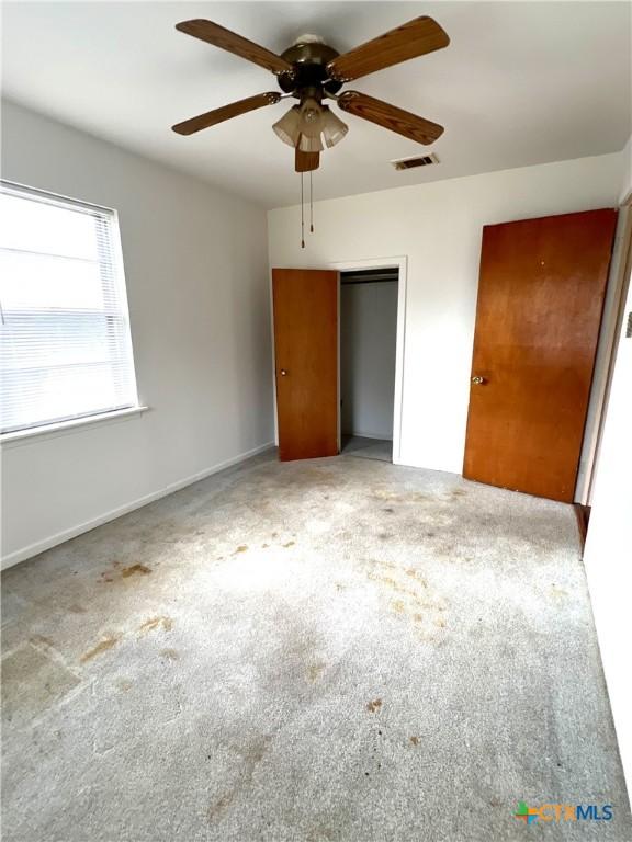 6769 Cedar Cove Rd, Belton, TX 76513 - unfurnished bedroom with carpet, a closet, and ceiling fan