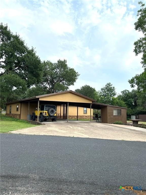 6769 Cedar Cove Rd, Belton, TX 76513 - ranch-style house featuring stone siding, driveway, and a carport