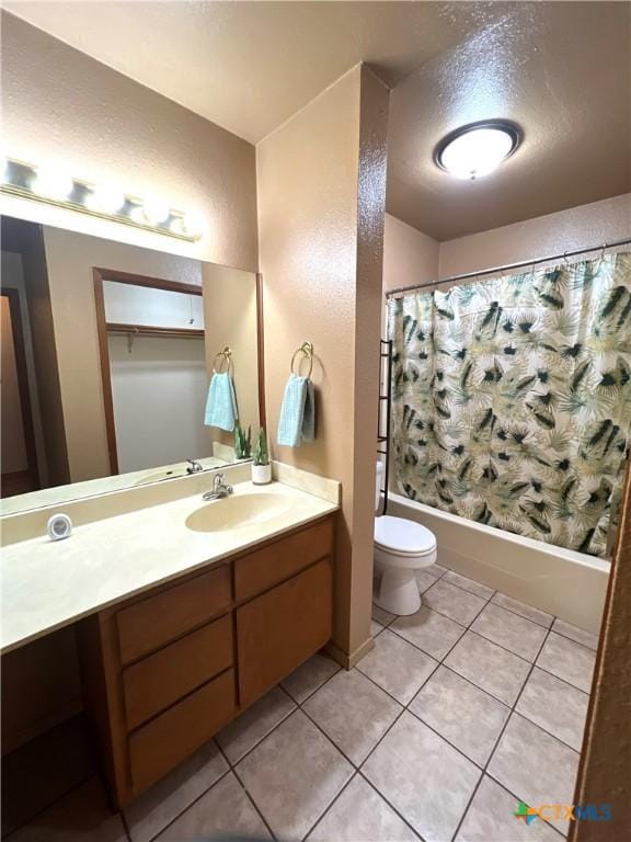 6769 Cedar Cove Rd, Belton, TX 76513 - full bath with vanity, toilet, shower / bath combo, tile patterned floors, and a textured wall