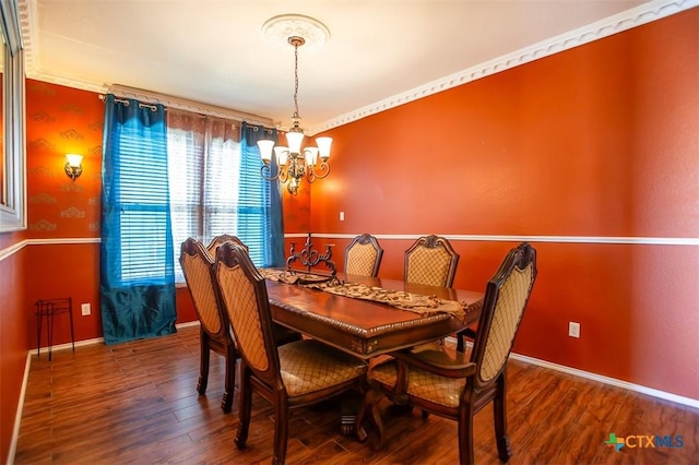 dining room featuring baseboards, an inviting chandelier, and wood finished floors