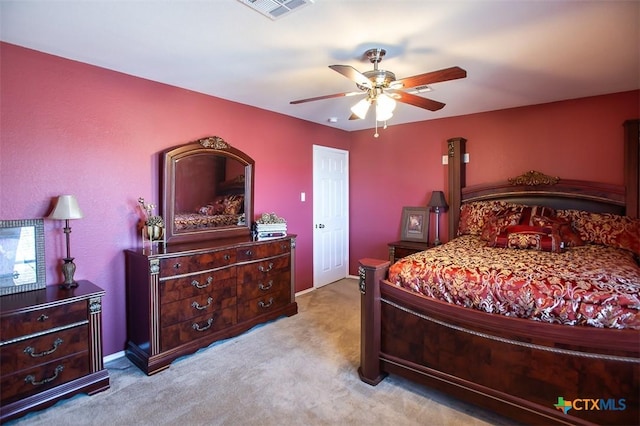 carpeted bedroom featuring visible vents and ceiling fan