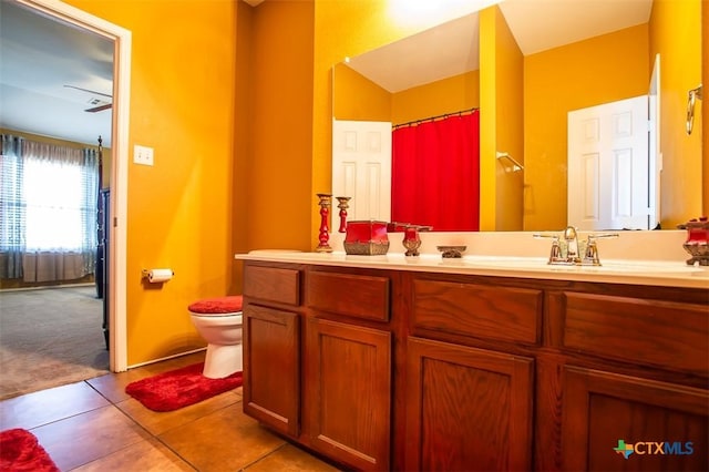 full bathroom featuring toilet, vanity, and tile patterned flooring