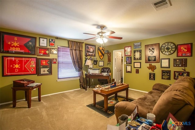 carpeted office with visible vents, baseboards, and a ceiling fan