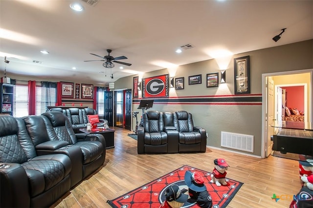 living area with recessed lighting, visible vents, and wood finished floors