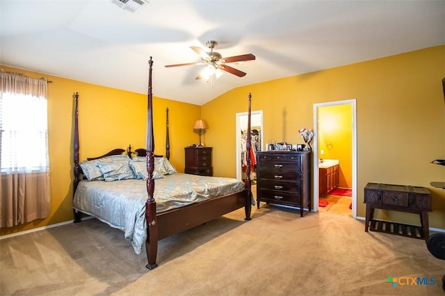 carpeted bedroom featuring a spacious closet, visible vents, connected bathroom, ceiling fan, and lofted ceiling