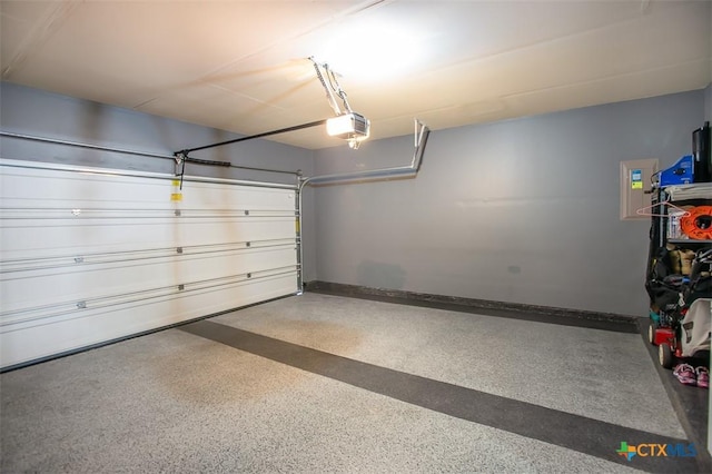 garage with a garage door opener and baseboards