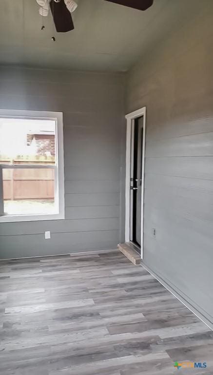 unfurnished room featuring wood finished floors and a ceiling fan