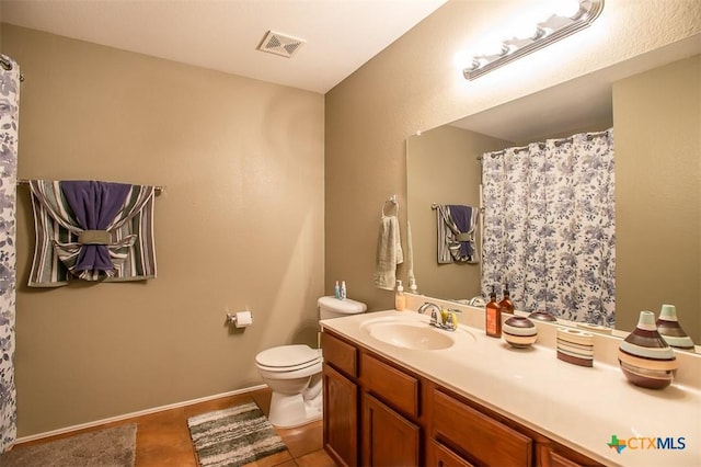 bathroom featuring vanity, toilet, baseboards, and visible vents