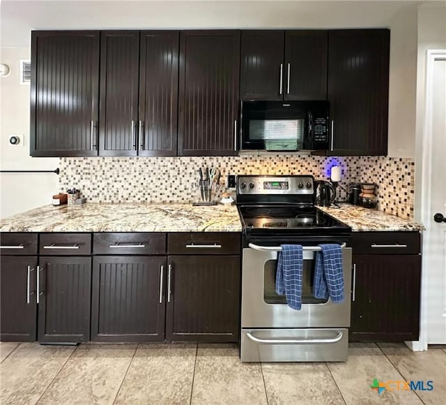 1106 Bowen Ave, Copperas Cove, TX 76522 - kitchen featuring black microwave, electric range, backsplash, and light stone counters
