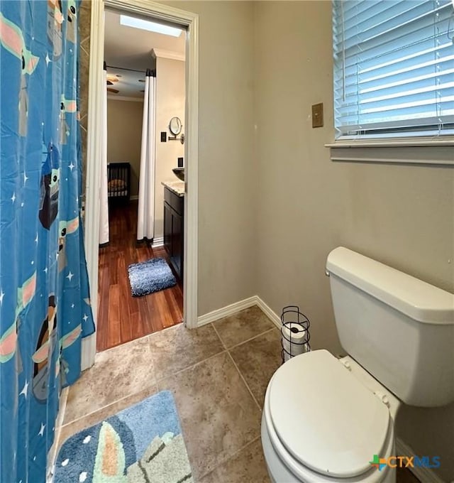 1106 Bowen Ave, Copperas Cove, TX 76522 - bathroom with toilet, baseboards, tile patterned flooring, crown molding, and curtained shower