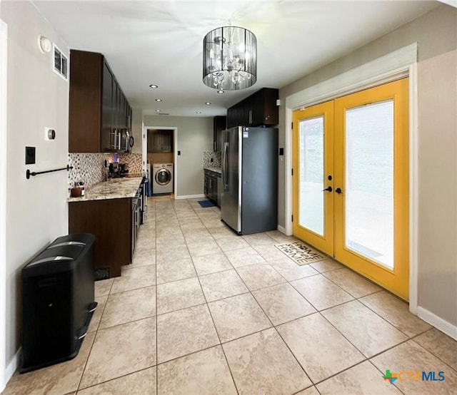 1106 Bowen Ave, Copperas Cove, TX 76522 - kitchen with freestanding refrigerator, washer / clothes dryer, french doors, backsplash, and healthy amount of natural light
