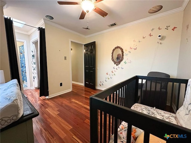 1106 Bowen Ave, Copperas Cove, TX 76522 - bedroom with wood finished floors, crown molding, baseboards, ceiling fan, and a nursery area
