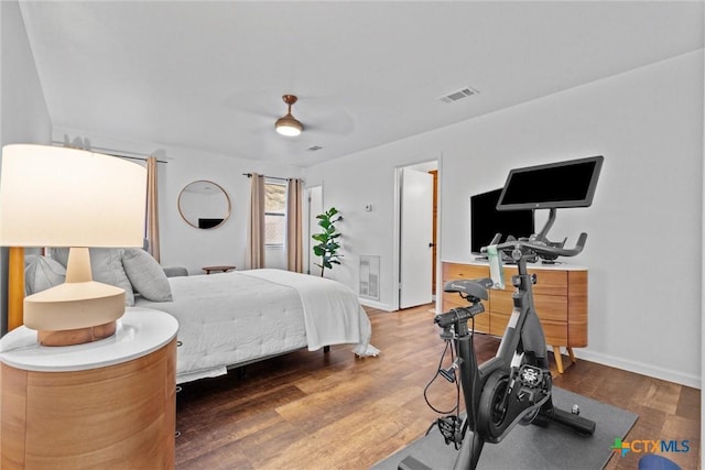 bedroom with dark hardwood / wood-style flooring and ceiling fan