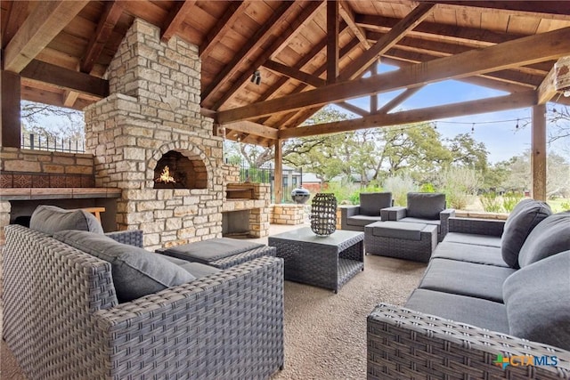 view of patio with a gazebo and an outdoor living space with a fireplace