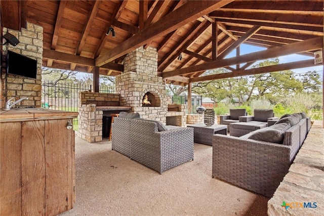 view of patio / terrace with a gazebo and an outdoor living space with a fireplace