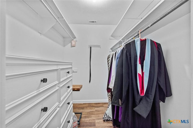 spacious closet featuring dark hardwood / wood-style floors