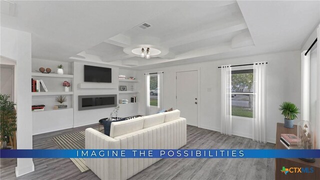414 Ellis St, Seguin, TX 78155 - living area with visible vents, built in shelves, wood finished floors, and a glass covered fireplace