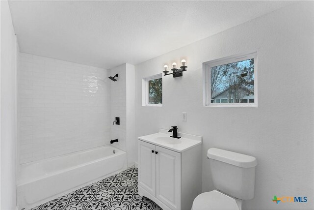 414 Ellis St, Seguin, TX 78155 - bathroom featuring tile patterned floors, toilet, vanity, and shower / bathtub combination